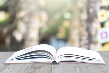Open Book with Green Blurred Nature Background.