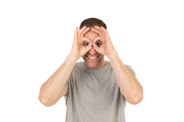 Naklejka premium Handsome guy looking through his hand