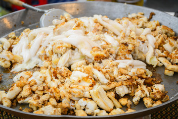 Squid eggs are fried in a frying pan. Thai Street Food.