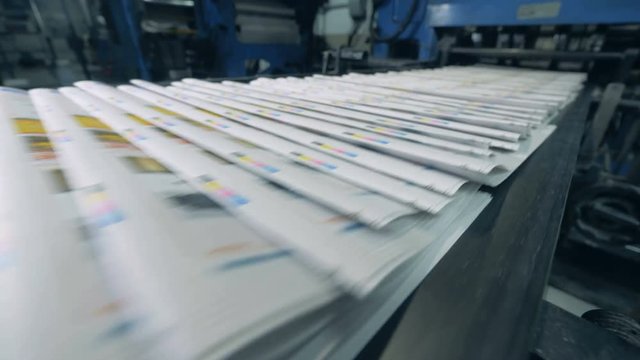 Printed journals are moving along the conveyor belt