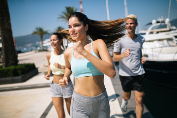 Healthy group of friends running and enjoying friend time together