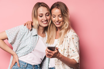 Two attractive blonde girls wearing summer outfit