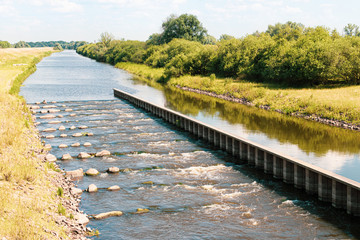 Fish ladder in the Sude, tributary of the Elbe near Boizenburg in nice summer weather.
