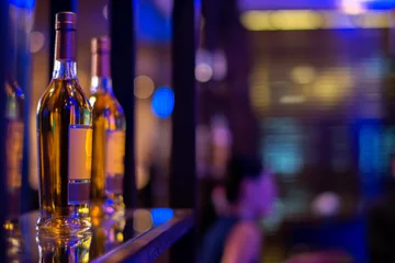 Foto op Plexiglas row of alcohol bottle on wooden shelf © lmanju