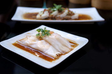 Chinese rice noodles rolls on a plate at Hong Kong dim sum restaurant