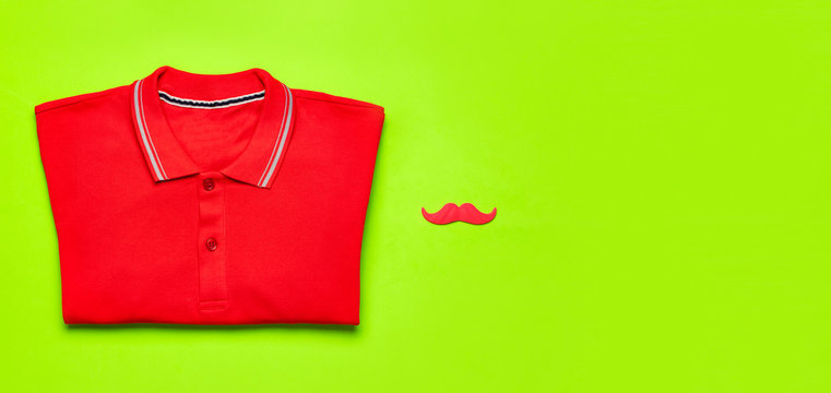 Creative Party Decoration Concept. Red Mustache, Red Polo Shirt, Props For Photo Booths, Carnival Parties On Green Background Top View Flat Lay Copy Space. Father's Day, Men's Clothes Accessories