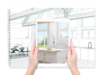 Hands holding tablet showing kitchen, notebook with blueprint sketch in the background, augmented...