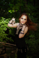 young woman dancing tribal in the forest