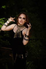 young woman dancing tribal in the forest