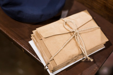 Stack of old letters on a wooden bookcase. Old mail of the post office