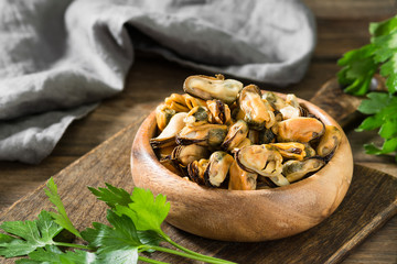 Mussel meat on a wooden Board on a wooden table. Rustic style