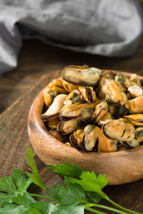 Mussel meat on a wooden Board on a wooden table. Rustic style