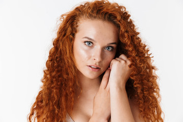 Portrait of an attractive woman with long curly red hair