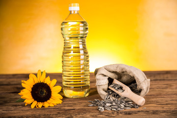 Sunflower oil in a bottle and sunflower seeds and sunflower