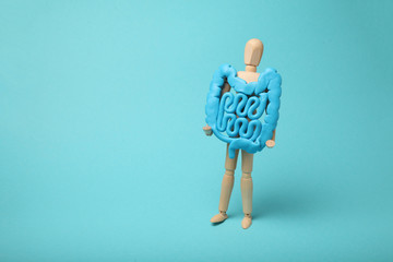 Healthy intestines in hands of human figure. Digestive problems, colic, dysbacteriosis.