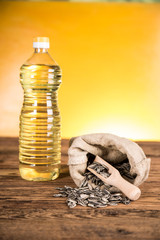 Sunflower oil in a bottle and sunflower seeds and sunflower