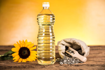 Sunflower oil in a bottle and sunflower seeds and sunflower