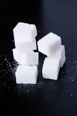 Sugar. Sweet cubes on black background
