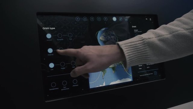 Man using control computer of the satellite orbit of spacecraft.