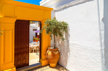 Ancient Greek architecture with traditional doors and decorative pavement in Lindos town, Rhodes...