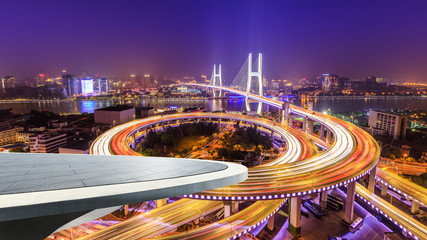 Fototapeta na wymiar Empty square platform and bridge buildings at night in Shanghai,China