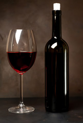wine glass with red wine on a stone background