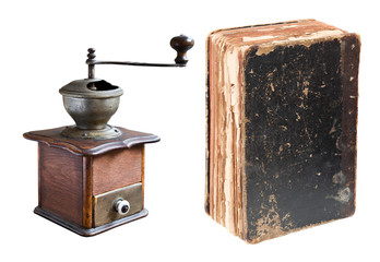 Antique coffee grinder and book isolated on white