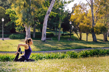 young woman doing yoga exercises in the nature