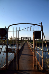 An old rusted bridge over the river Po - Italy