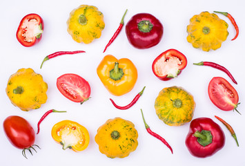 Organic vegetables background with fresh tomatoes, squash and pepper on a light gray.
