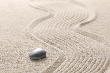 Fototapeta na wymiar zen ston on raked sand with copy space for your text