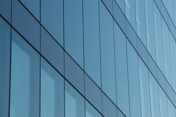 Fototapeta na wymiar blue office building windows background for brochure covers or web design
