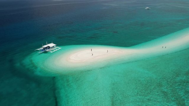 Aerial view of traditional boats on the shore of a beautiful tropical island (Kalanggaman)