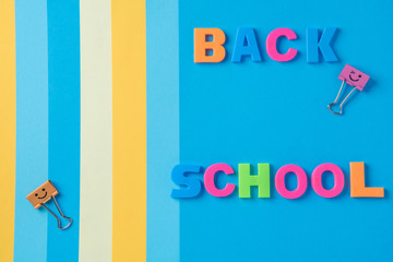 The inscription back to school plastic letters on the background of paper