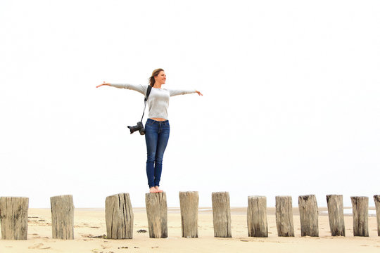 Young woman taking pictures at the beach