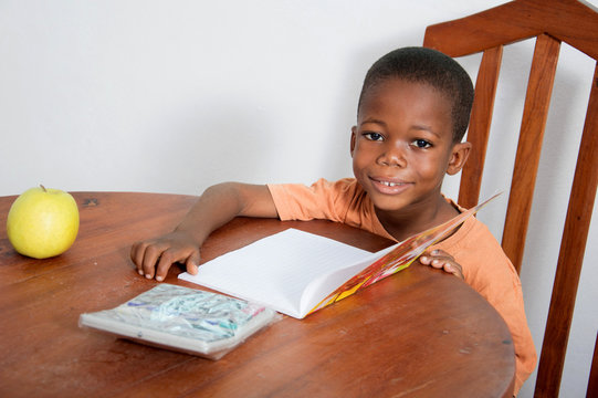 This child is very happy to study evening at home.