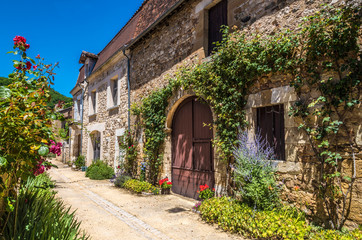 France, Dordogne, Perigord Vert, Saint-Jean-de-Cole (Plus Beau Village de France - Most Beautiful Village in France), peasant houses with flowers along the street