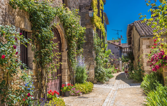 France, Dordogne, Perigord Vert, Saint-Jean-de-Cole (Plus Beau Village de France - Most Beautiful Village in France), peasant houses with flowers along the street