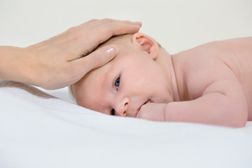Mother's hand on infant's head