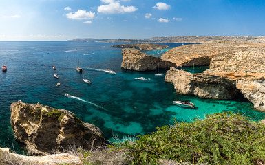 Panorama of Comino island coast  with a lot of ships, Malta