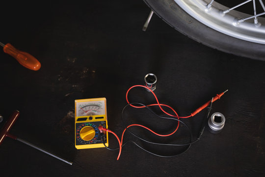 Motor testing multimeter and tools on floor