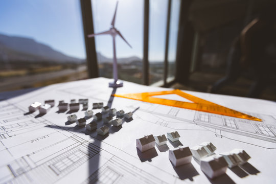 Close up of house model over blueprint on desk