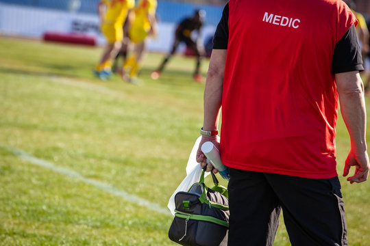 Medic From The Edge Of The Field Watching The Game