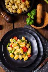 crispy gnocchi with roasted asparagus and tomatoes