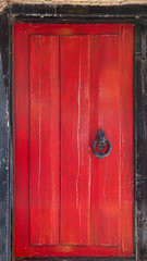 Old red wooden door in a Greek Town