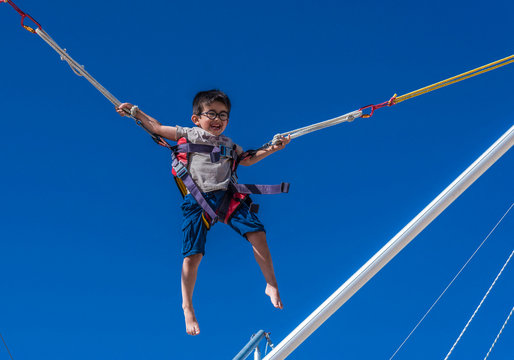 Five-year-old boy doing bungee trampoline