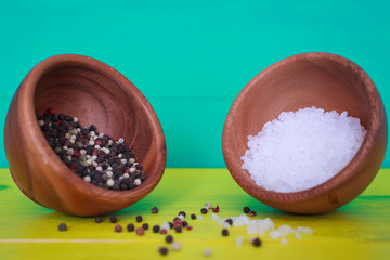 salt and pepper on a plate on a colorful background 