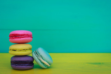 multicolored macarons on yellow-blue background