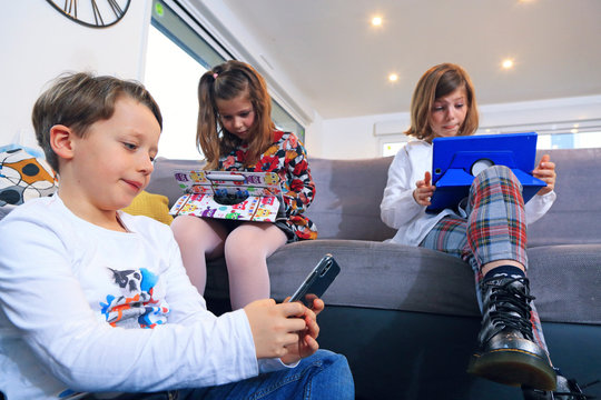 Children with smartphone and laptop