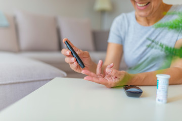Close-up photo with a woman who is testing her level of glucose in her blood. Diabetes doing blood...